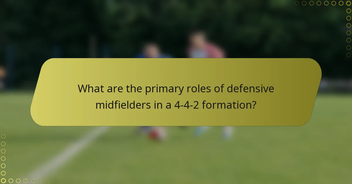 What are the primary roles of defensive midfielders in a 4-4-2 formation?
